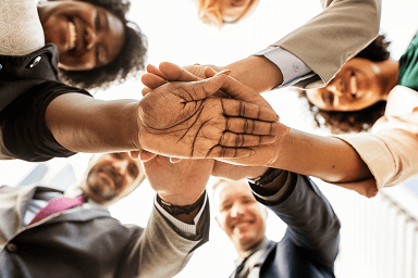 Team members joining hands together